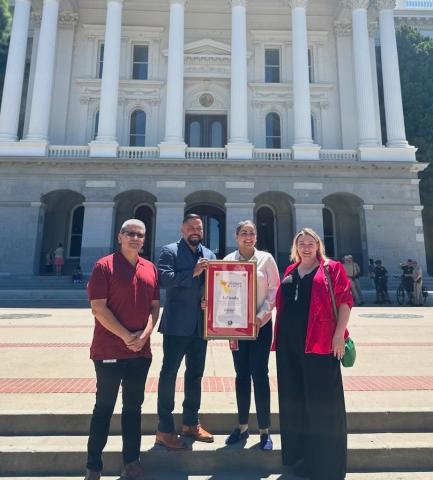Senator Wahab poses with La Familia staff members in front of the Capitol building.
